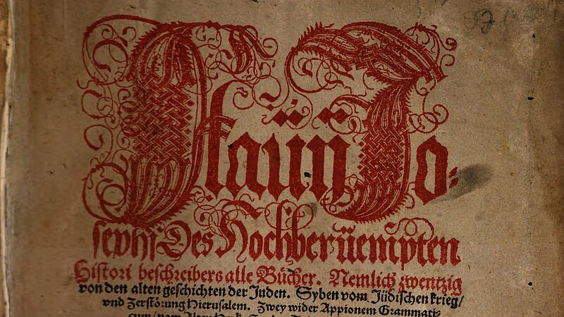 Altes Buch-Titelblatt mit roter und schwarzer Schrift, rot verziert.