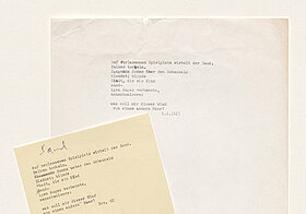 Two sheets of paper with the same poem typed on it