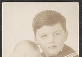 Old picture of a boy in a uniform and a baby