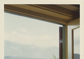 Foto aus dem Fenster mit Blick auf Balkon und Berge.