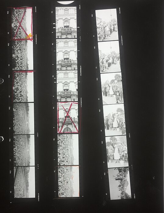Drei schmale Streifen mit Fotos, einige sind rot markiert.