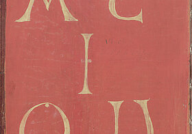 Rotes Buchcover mit goldenen Lettern "A E I O und U"