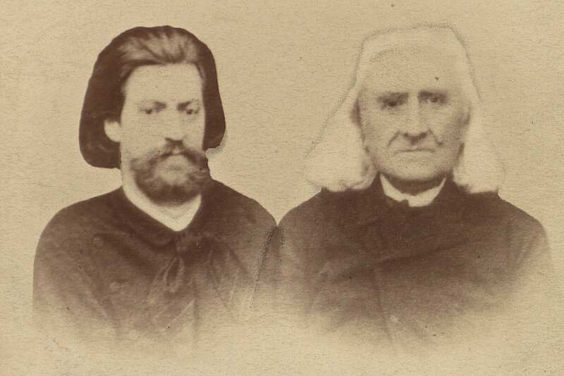 Altes Foto von zwei Männern, beide mit langen Haaren, einer dunkel mit Bart, der andere weißhaarig