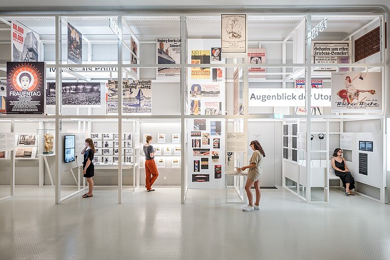 Foto von weißem Museumsraum mit Besucher*innen.