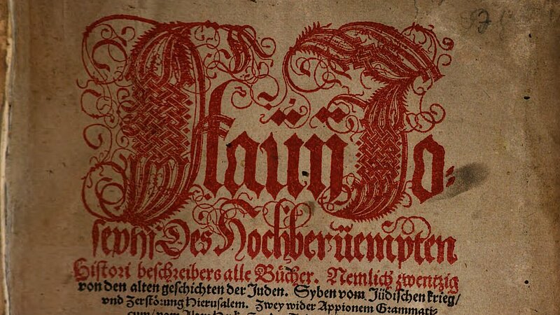 Altes Buch-Titelblatt mit roter und schwarzer Schrift, rot verziert.