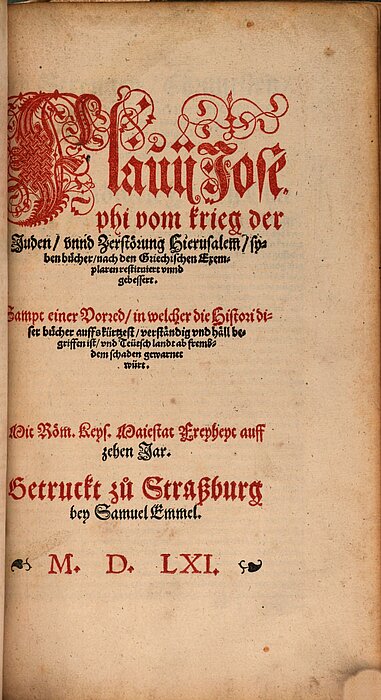 Altes Buch-Titelblatt mit roter und schwarzer Schrift, rot verziert.