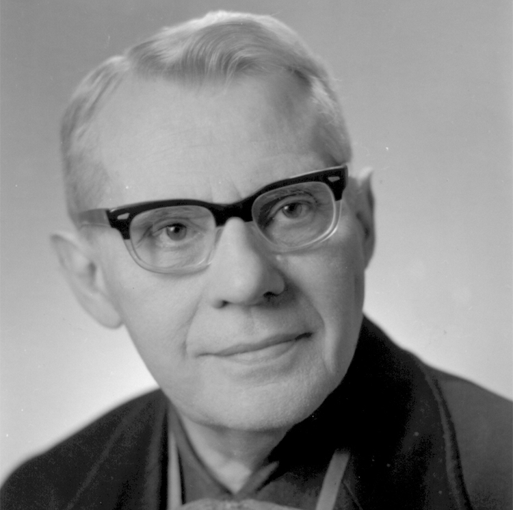 Porträtfoto von einem Mann mit hellen Haaren und Brille mit dunklem Rahmen, schwarz-weiß